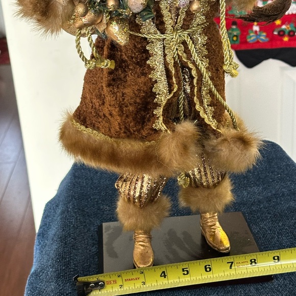 Golden velvet clad Santa holds greenery. - Picture 7 of 7